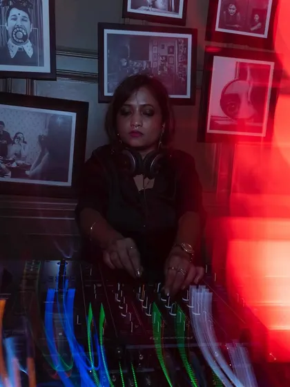 A moment of focus at Hi-Pitch Bangalore, a venue known for its dedication to underground music. The red lighting and intense atmosphere are perfect for the deep techno sets I love to play.