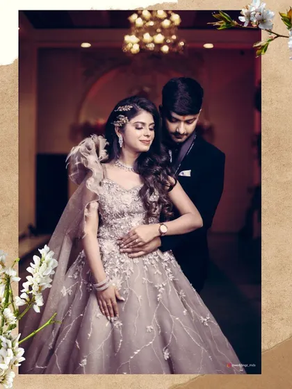 An elegant portrait of the engaged couple, showcasing the bride's stunning gown and the couple's graceful pose.