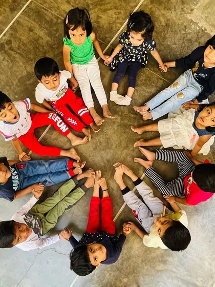 A circle of friends, ready for the next fun game. These moments of connection are just as important as the physical exercise itself, helping to build friendships and social confidence.