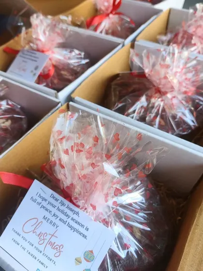 We add personalized notes to our corporate Christmas gifts to make each employee feel appreciated. These gift boxes with rum-soaked plum cakes were a huge hit.