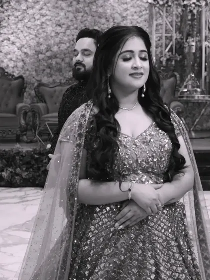 A smile is the beginning of love. This black and white photo captures a serene and romantic moment between the couple during their reception.