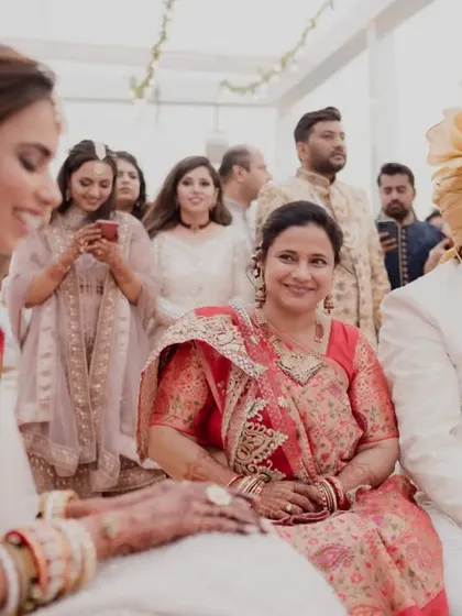 A mother's proud and happy smile as she sits beside her daughter during the wedding ceremony. These are the family moments we cherish.