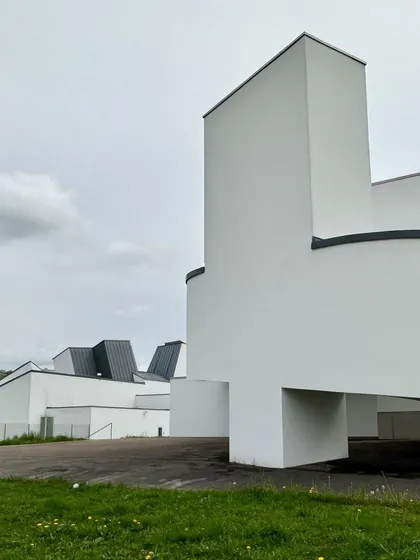 The powerful, sculptural forms of the building's exterior. This early work shows a raw creativity and a departure from conventional architectural geometry.
