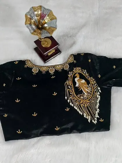 The full view of the black velvet peacock blouse, a true statement piece.