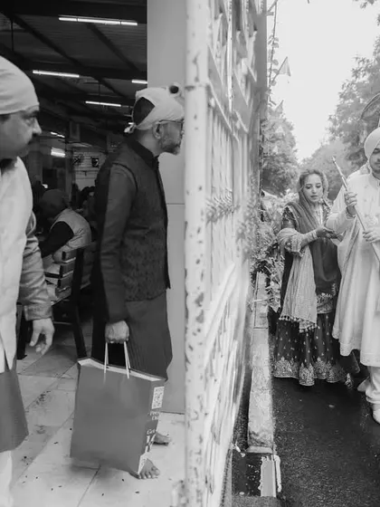 The groom and his family arriving at the Gurdwara. I document the entire journey of the wedding day, starting from these early moments.