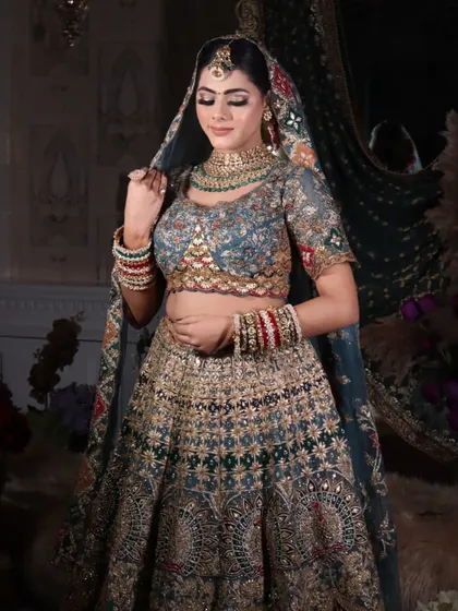 This shot captures the bride adjusting her dupatta, highlighting the soft glam makeup and the intricate embroidery on her outfit.