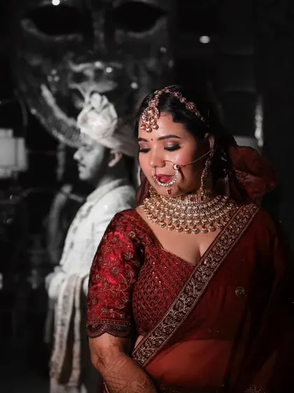A creative black and white portrait of the bride, with the groom's silhouette in the background. This colour splash technique creates a striking and memorable image.
