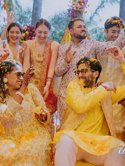 The couple dancing and celebrating under a shower of yellow petals.