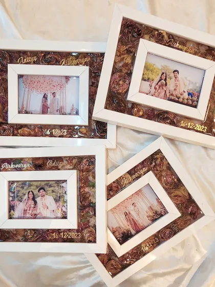 I made this set of four matching shadow box frames for a wonderful couple to give as gifts to their family. Each frame preserves their varmala flowers alongside a beautiful wedding photo, their names, and the date, all handcrafted with love.