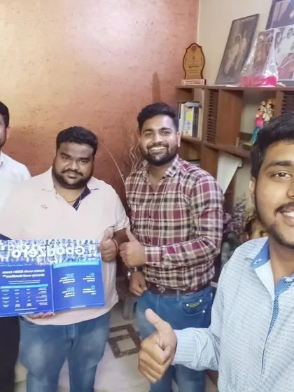 Our team takes a selfie with a group of customers holding our "GoodZero" brochure.