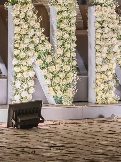 A closer look at the 'N' and 'N' of the floral brand name installation, highlighting the sheer volume of flowers used.