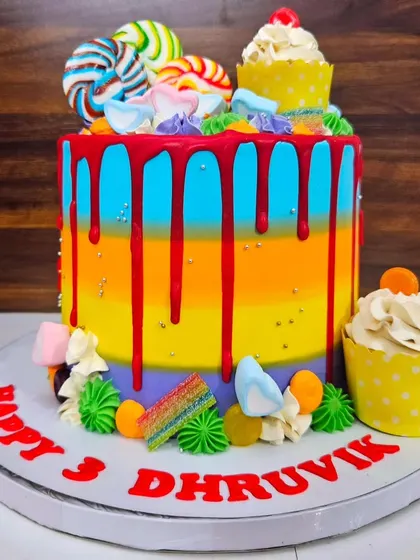 DJ's candy cake for his 3rd birthday. This colorful butterscotch cake is loaded with lollipops, marshmallows, and sour punk candies.
