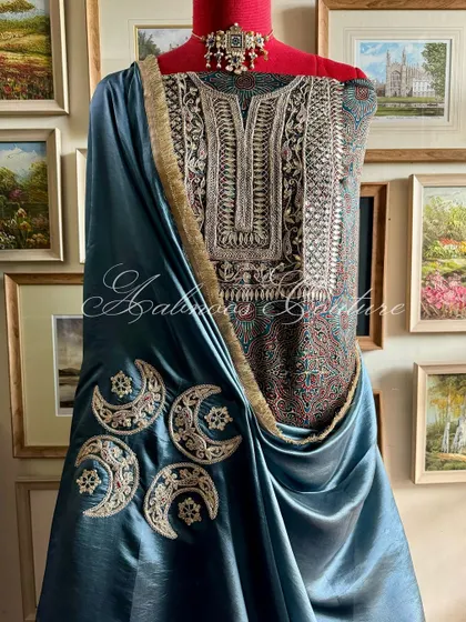 This ensemble showcases a masterful blend of textures and traditions. A modal silk kurta featuring intricate Gota Patti and Marodi hand embroidery is paired with a lustrous Italian silk organza dupatta, adorned with celestial moon motifs.