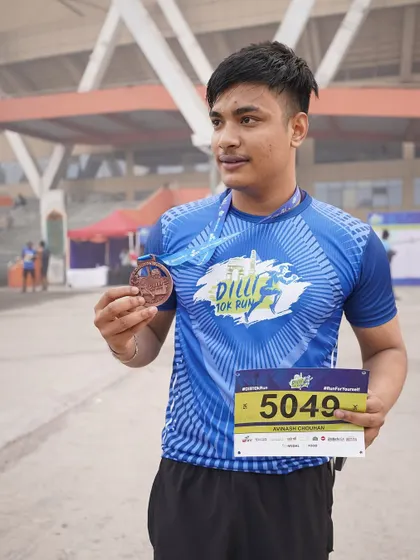 A proud moment for one of our younger members, medal in hand after the Dilli 10K run. It's great to see this level of dedication.