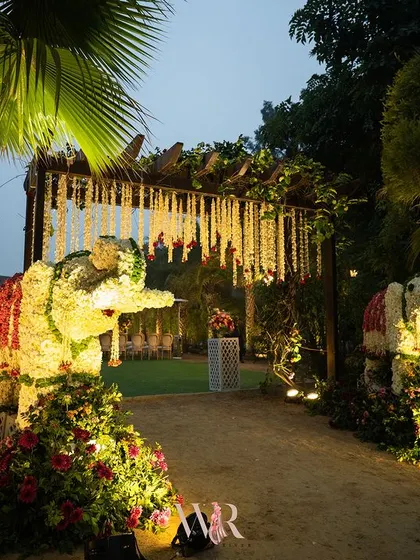 Two magnificent elephants, sculpted from white and red flowers, stood guard at this wedding entrance. This display of floral artistry, inspired by Indian royalty, offered a grand and traditional welcome, symbolizing blessings for the couple's new journey.