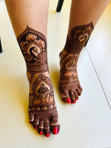 A beautiful peacock and lotus design for the feet, created to match the bride's hand henna. The patterns are bold and clear.