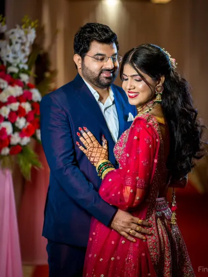 A classic reception portrait. The couple's elegant attire and the warm, ambient lighting of the venue create a sophisticated and romantic image.