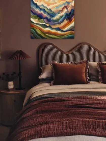 The right artwork can complete your bedroom decor. This colorful abstract piece is placed above the bed to add a personal touch and a splash of color to this cozy, modern sleeping space.