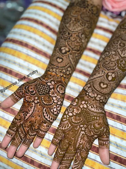 This detailed design was for an engagement bride. It features delicate hearts and intricate netting, covering the hands and arms completely for a traditional look.