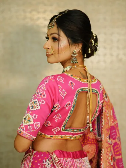 The back view of the blouse and the neat floral bun. Every detail matters when creating the perfect bridal look.