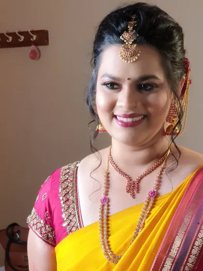 A close-up of Archana's happy expression. The soft, natural makeup allows her radiant smile to shine through, perfect for this traditional ceremony.