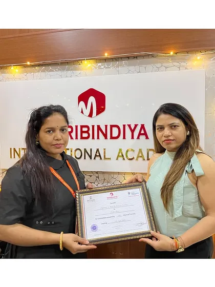 Another student successfully completes her training, holding her certificate with pride.