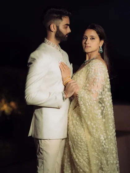 A modern and stylish portrait from a rooftop engagement shoot in Mumbai. The city lights create a magical backdrop.