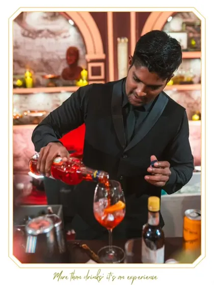Our bartender preparing a vibrant Aperol Spritz. This shot highlights the fresh ingredients and careful technique used to create this classic, refreshing cocktail.