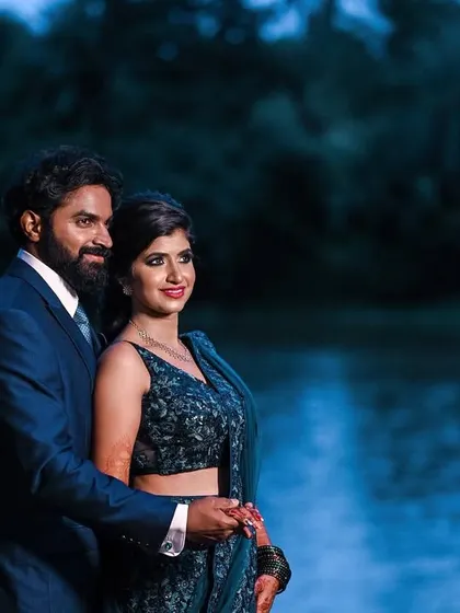 A beautiful evening portrait of a couple by the water, with the blue tones creating a serene and romantic mood.