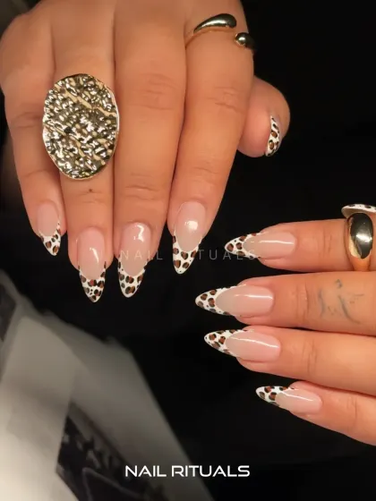 A full view of this wild and chic set. The cow print tips paired with bold gold jewelry create a look that is both trendy and timeless.