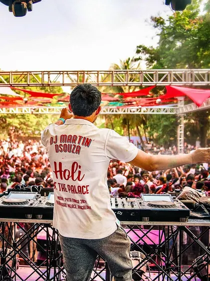 A shot from behind the decks at the 'Holi At The Palace' event, showing my custom shirt and the massive crowd in front of me.