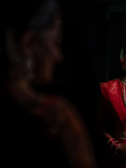 A creative portrait of the bride, using reflections and shadows to create a sense of mystery and art. We love experimenting with different techniques to tell a unique story.