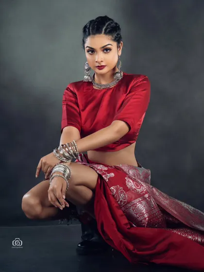 A powerful crouching pose that adds an athletic, modern edge to the traditional saree. This shot is all about attitude and breaking fashion boundaries.