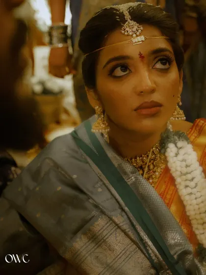 A stunning close-up of a South Indian bride during her wedding ceremony, her eyes looking up with hope and devotion.