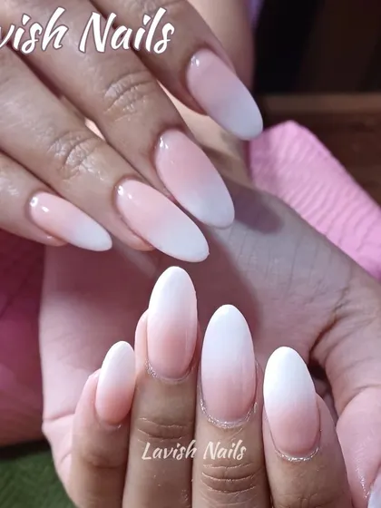 A soft and delicate ombré effect on long, almond-shaped nails, creating an elongated and graceful appearance.
