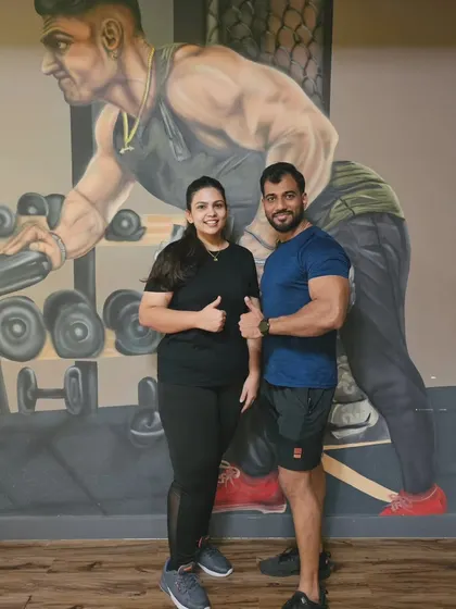 A duplicate of image 66, celebrating the client's success with her trainer.