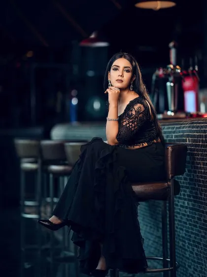 A wider shot that captures more of the bar's ambiance, setting a complete scene for this modern, high-fashion look.