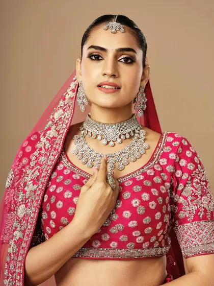 My student Drishika created this radiant bridal look. The makeup enhances the model's features while perfectly matching the vibrant pink outfit and diamond jewelry.