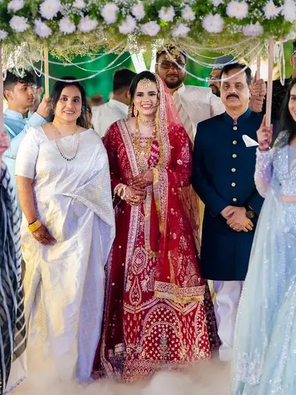 The bride's entrance with her family, walking through a beautifully lit path. This photo captures the magic and importance of her arrival.
