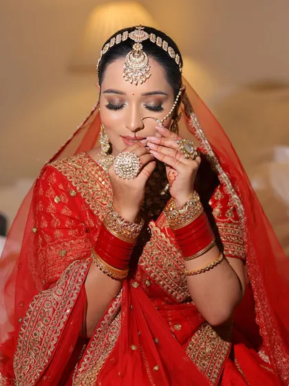 This candid moment captures the bride's glowing skin and intricate details of her look. The makeup is set to be picture perfect from every angle, from the ceremony to the reception.