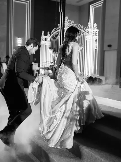 A 60s Glam Reception: Inspired by the unapologetic glamour of the 60s, this couple's reception look was timeless and chic, captured beautifully in this black and white shot.