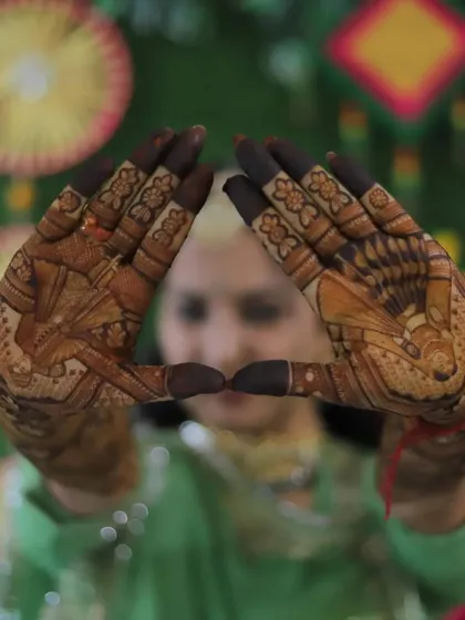 A creative pose highlighting the beautiful portraits on the bride's palms.