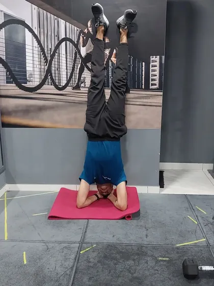 A demonstration of a supported headstand, a great calisthenics exercise for building shoulder stability, core strength, and balance.