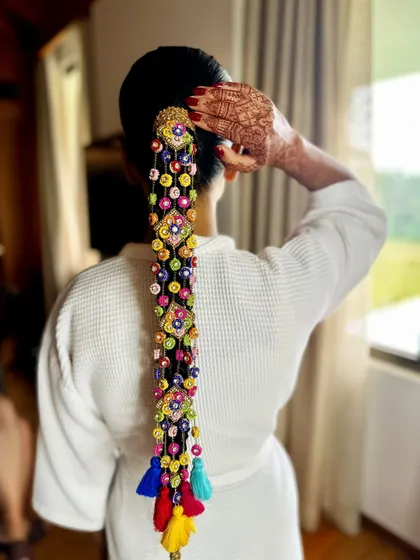 A getting-ready shot showing the beautiful hair accessory before the full outfit. The detail and craftsmanship are incredible.