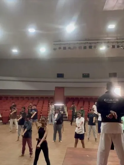 A coach leads a group of adult students in a karate seminar at NIFT, part of their academic curriculum.