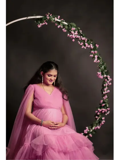 Our floral ring prop adds a beautiful, whimsical element to maternity photos. It pairs perfectly with the pink ruffle gown for a soft, romantic themed shoot in the studio.