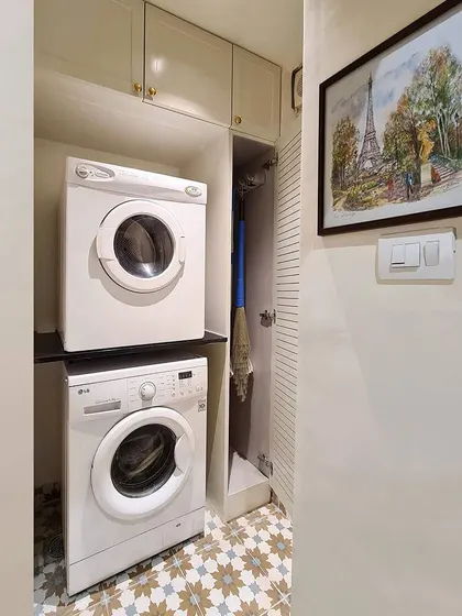 I believe even utilitarian spaces deserve to be beautiful. I did a full gut remodel of a small bathroom to create this super functional laundry room, with a stacked washer and dryer and a ventilated broom closet.