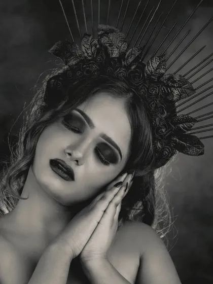 A black and white version of the creative gothic look, emphasizing the textures and dramatic shapes of the makeup and headpiece without the distraction of color.