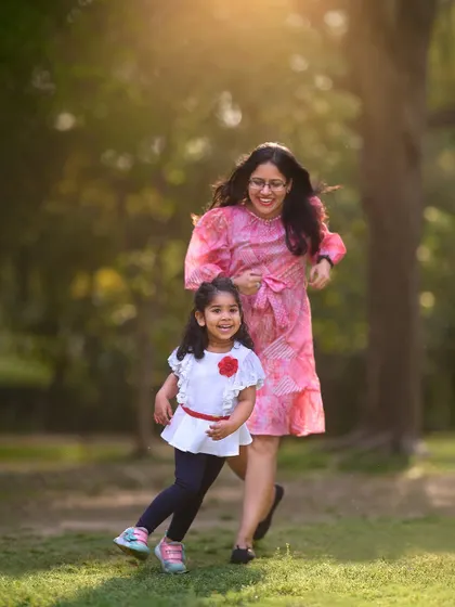 A candid moment of mother and daughter running and laughing together. I strive to make every photoshoot a fun experience, resulting in natural and joyful images like this one.