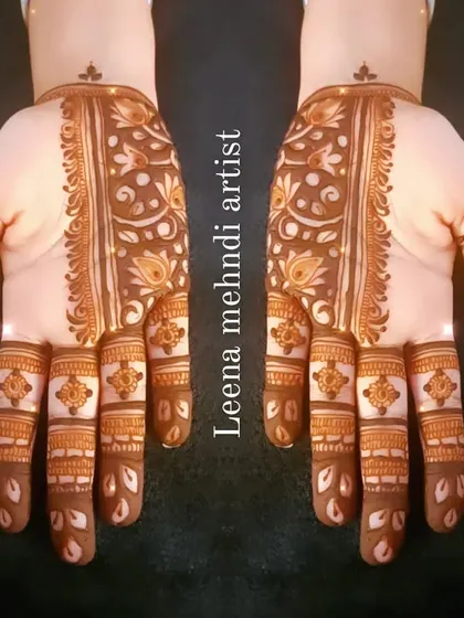 The finished Arabic strip design. The pattern runs down the center of the hand, adorned with floral and leaf motifs.